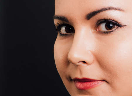 Portrait of a woman's perfect skin - isolated on black.の写真素材