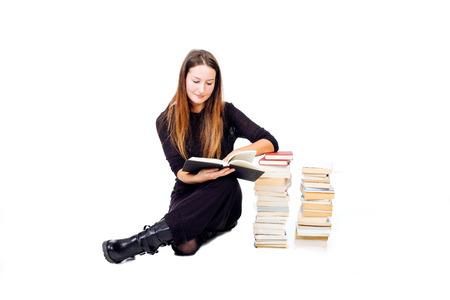 Capture of a two pile of books and of a woman studying one of them - isolated on white.