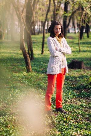 Cute girl in the park, smiling and enjoying the momentの写真素材