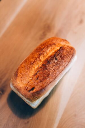 View of a fresh baked bread on a wooden tableの写真素材