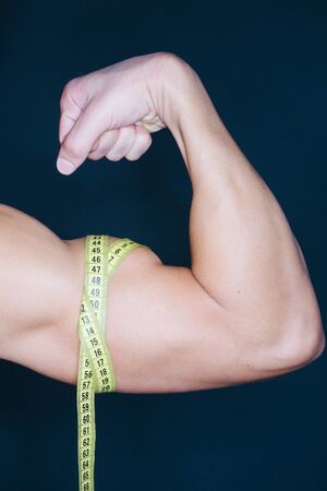 Pose of a tense biceps with a tape on itの写真素材