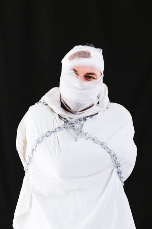 Mentally insane patient in chains and straitjacketの写真素材