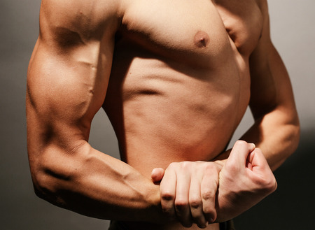 Torso of a man's perfect biceps and chestの写真素材