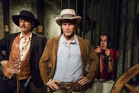 Los Angeles, CA, USA - July 6, 2013: Madame Tussaud's Hollywood figures - female tourist in jail behind Robert Redford and Paul Newman.のeditorial素材