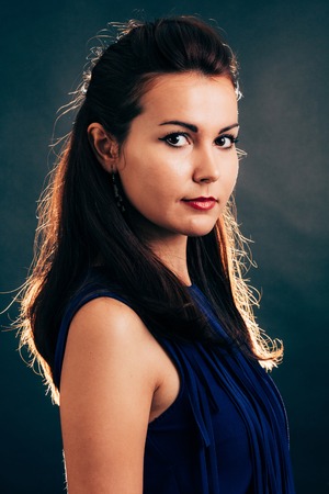 Side portrait of a fashion brunette woman - isolated on black.