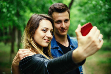 Young woman taking a selfie in the park