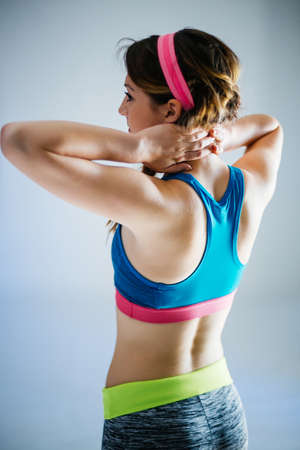 Profile of a fit woman stretching her arms and backの写真素材