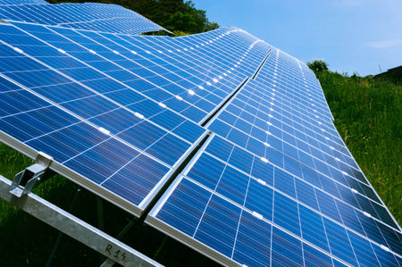 Modern solar panels lined up with sunny rays reflecting on them