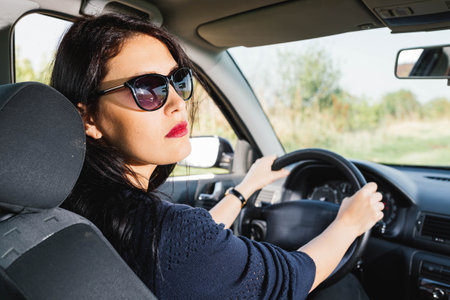 Woman driving a car and looking at the camera ,close-up picture.の写真素材