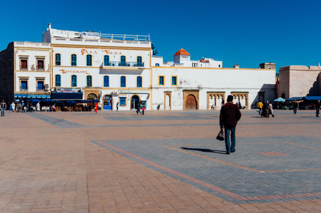 Essaouira, Morocco- February 6, 2015: Pose of a back of a man walking in the square of Port Essaouira , Morocco.のeditorial素材