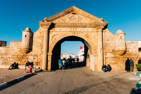 Essouira, Morocco- February 6, 2015: People admiring beautiful ancient gate in a sunny day in Morocco.のeditorial素材