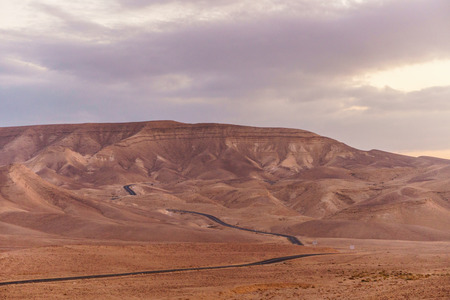 Scenic landscape of magic pink sky and sunrise over judean desert in Israel holy land. Beautiful blue yellow and orange clouds with sunlight. Nobody on photoの写真素材