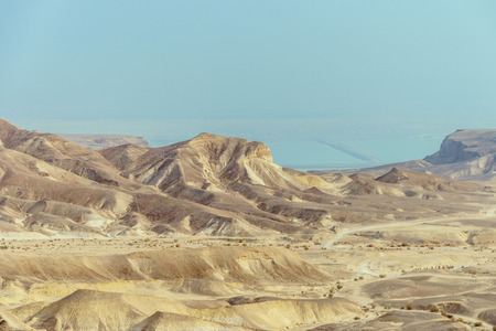 Sunny landscape view on the dead sea from desert in Israel. Valley of sand, mountains and stones in...
