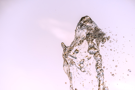 Abstract water wave drop in motion with color background. Natural water splash and bubbles in closeup macro view. Fresh and clean aqua splashing and falling energy.の写真素材