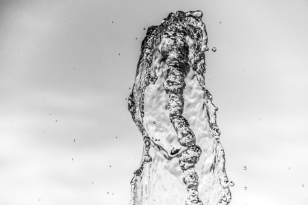 Abstract water wave drop in motion with color background. Natural water splash and bubbles in...