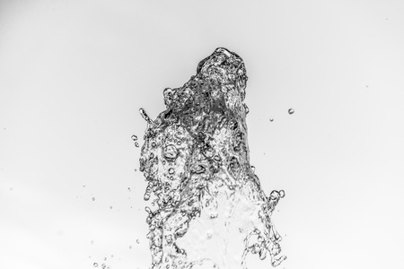 Abstract water wave drop in motion with color background. Natural water splash and bubbles in closeup macro view. Fresh and clean aqua splashing and falling energy.の写真素材