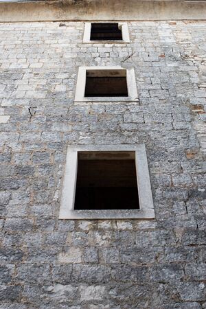 Windows on old wallの写真素材