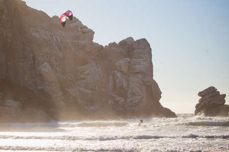 A single kiteboarder at Morro Rock, California, in the late afternoon.の写真素材