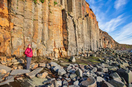 A female hiker with the basalt columns at KÃ¡lfshamarsvÃ­k, Iceland.の写真素材
