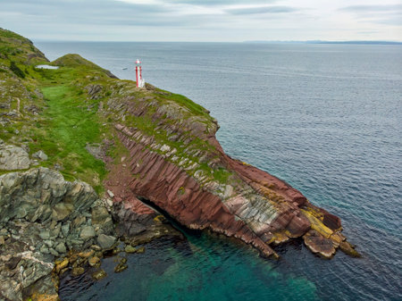 An aerial shot of the Brigus Lighthouse on the rocky coast of Newfoundland, Canada.の写真素材