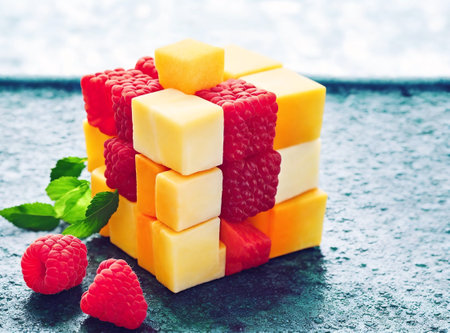 Fruit cube with raspberries and melon on a dark backgroundの素材