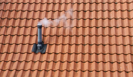 Smoking chimney on rooftopの写真素材