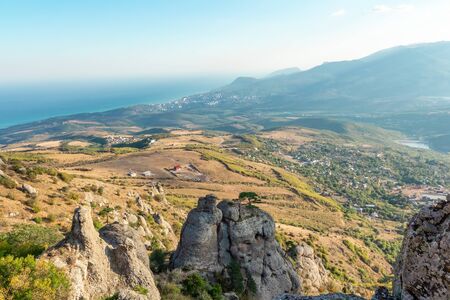 Magnificent panoramic view from top of rocky mountain to picturesque valley with villages and sea. Wonderful wallpaper of Crimeaの写真素材