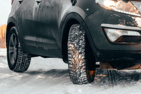 Rubber winter wheels in cold snowy weather on slippery road. Danger of skidding or accidents when...