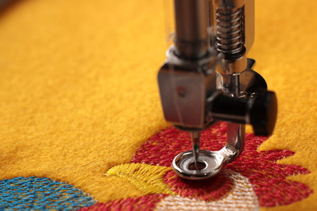 Rooster on yellow felt - embroidery with embroidery machine - Close up - Background and needle bar blanked out blurry
の写真素材