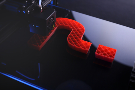 3D-printer producing big sculptural question mark from red plastic in blue neon light mood - dark surrounding - technology opportunity concept - background blanked out blurryの写真素材