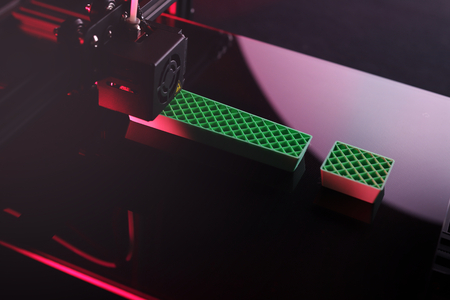 3D-printer producing big sculptural exclamation mark from green plastic in pink neon light mood - dark surrounding - technology opportunity concept - background blanked out blurryの写真素材