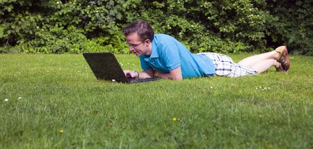young man with laptop working outside の写真素材