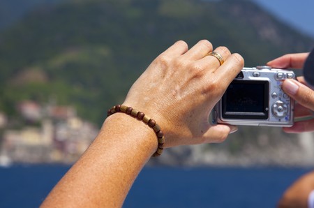 woman taking picture of the mountains