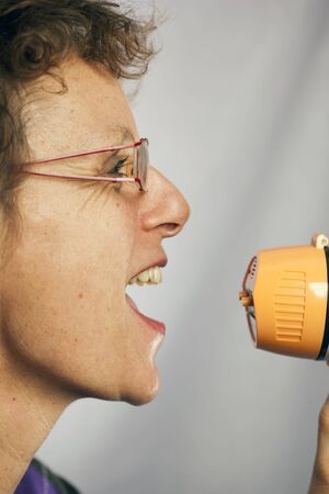 young woman shouting through a megaphone 