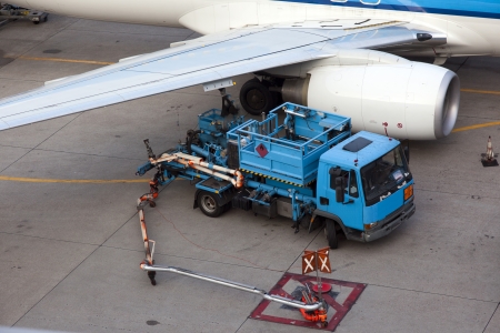 refueling a plane on the airport の写真素材