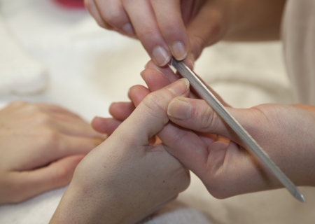 Pair of mature hands having the nails filed の写真素材
