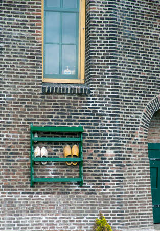 Traditional wooden dutch shoes outside a windmill.