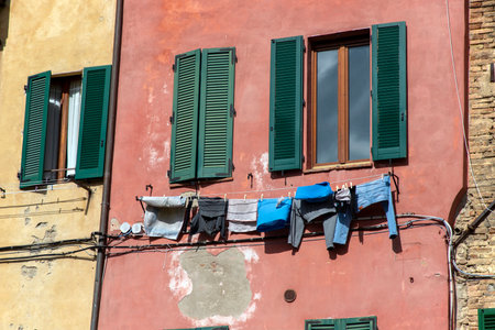 laundry outsiide the window from a residential building in Sienaの写真素材