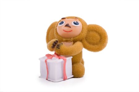 Toy creature with very big ears holdin the gift box isolatedの写真素材