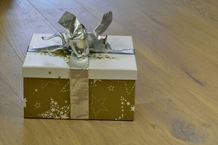 Christmas present on wooden floorの写真素材