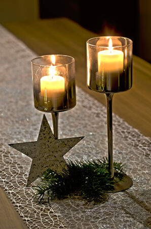 Pair of candlestick holders with burning candlesの写真素材