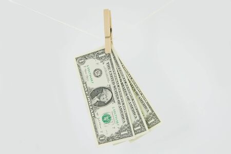 Drying dollars on rope on white backgroundの写真素材