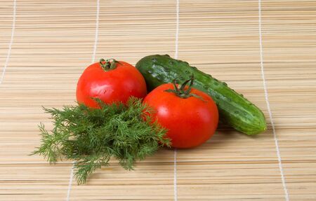 Tomato fennel cucumber on bamboo backgroundの写真素材