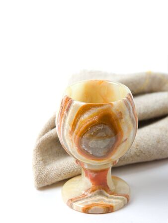 Antique stone glass and napkin on tableの写真素材