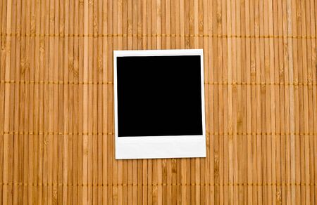 Blank photo frame on bamboo backgroundの写真素材
