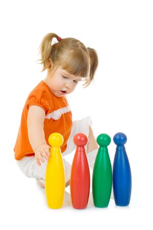Little funny girl with toys isolatedの写真素材