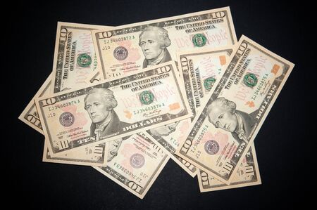 Heap of dollars on blackの写真素材