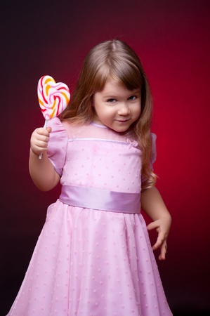 Little smiling girl with lollipopの写真素材