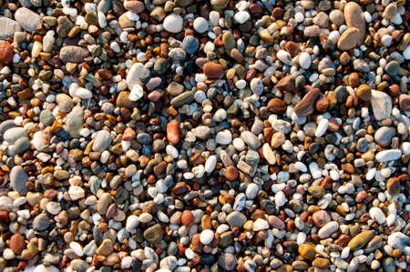 Wet pebbestone background on sea shore