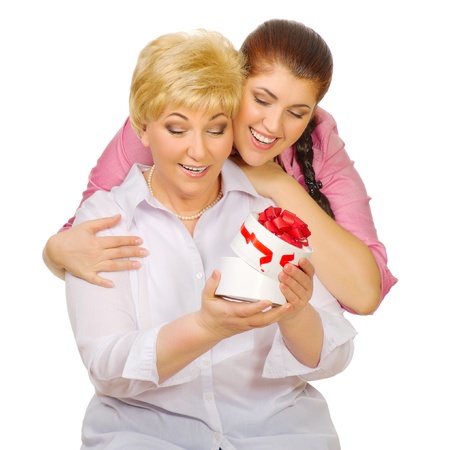 Senior and young woman with gift isolatedの写真素材
